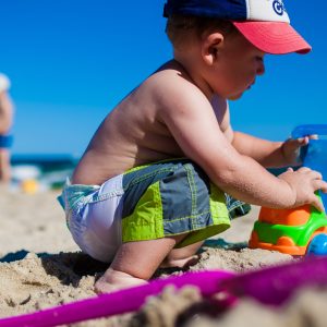 Boy playing with sand at Beach.